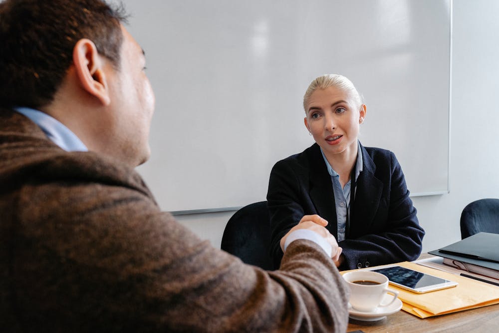 Multiracial colleagues shaking hands in office